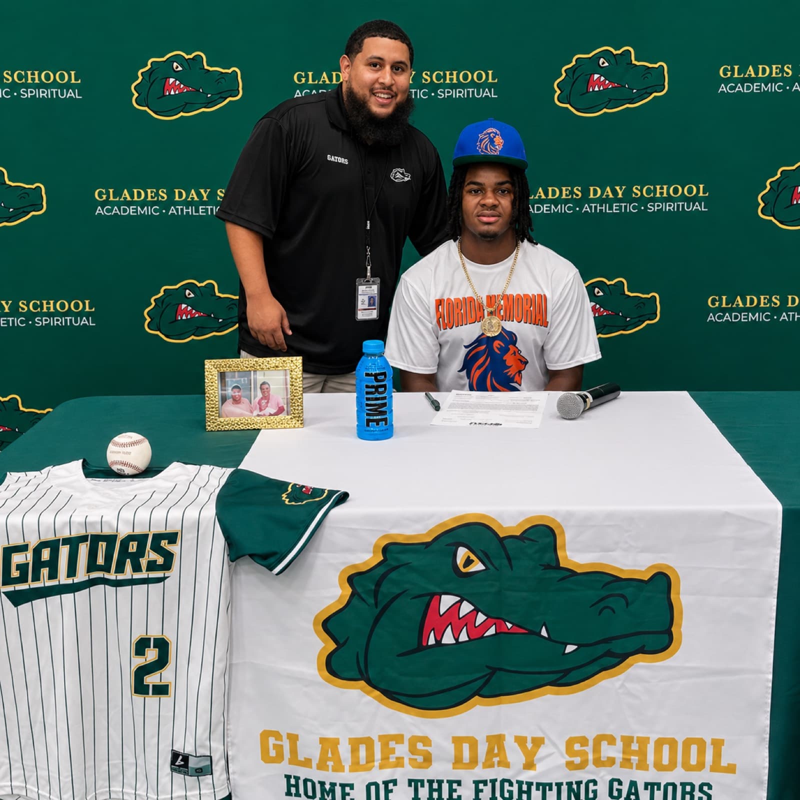 Rene Leon Jr. with a Glades Day School player who signed to Florida Memorial University